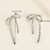 e8f8e74e-1b4a-11ef-8971-0a580a682b00.jpg Trendy Hollow-Out Bow Stud Earrings